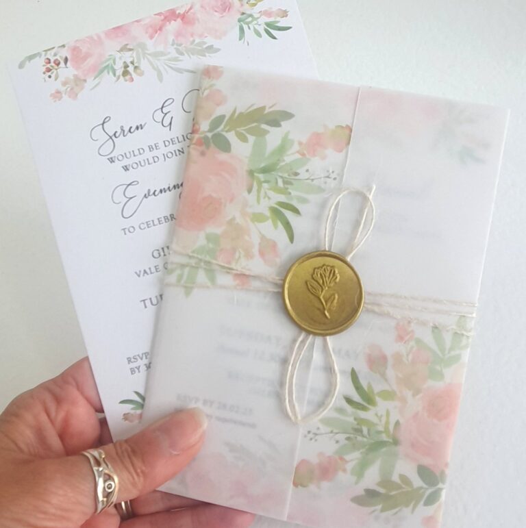 blush pink lforal wedding invitation with vellum wrap and gold wax seal 768x771
