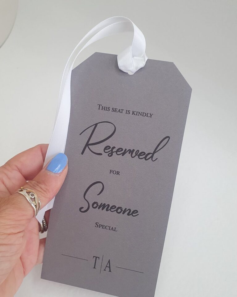 grey reserved seating tag with white ribbon 768x961